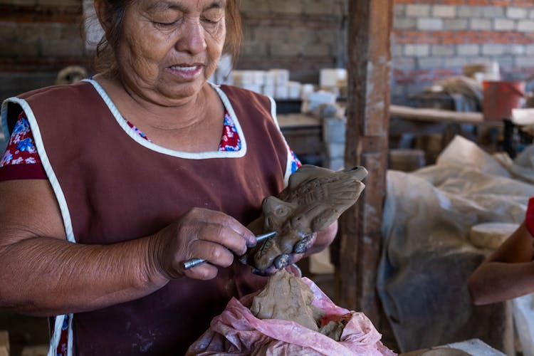 Woman Making A Clay Sculpture