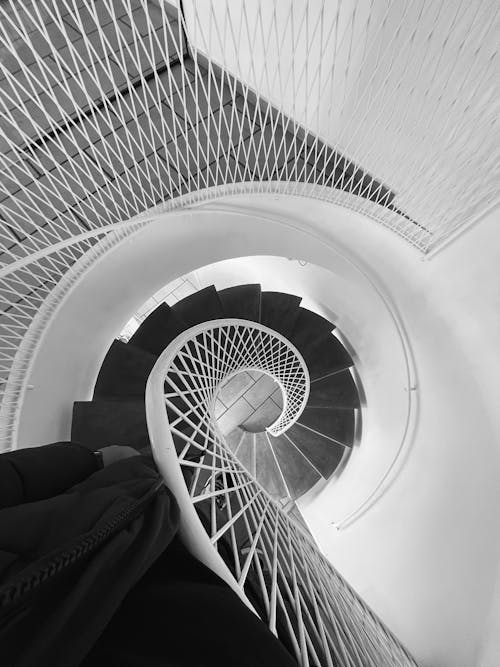 Grayscale Photo of Spiral Staircase