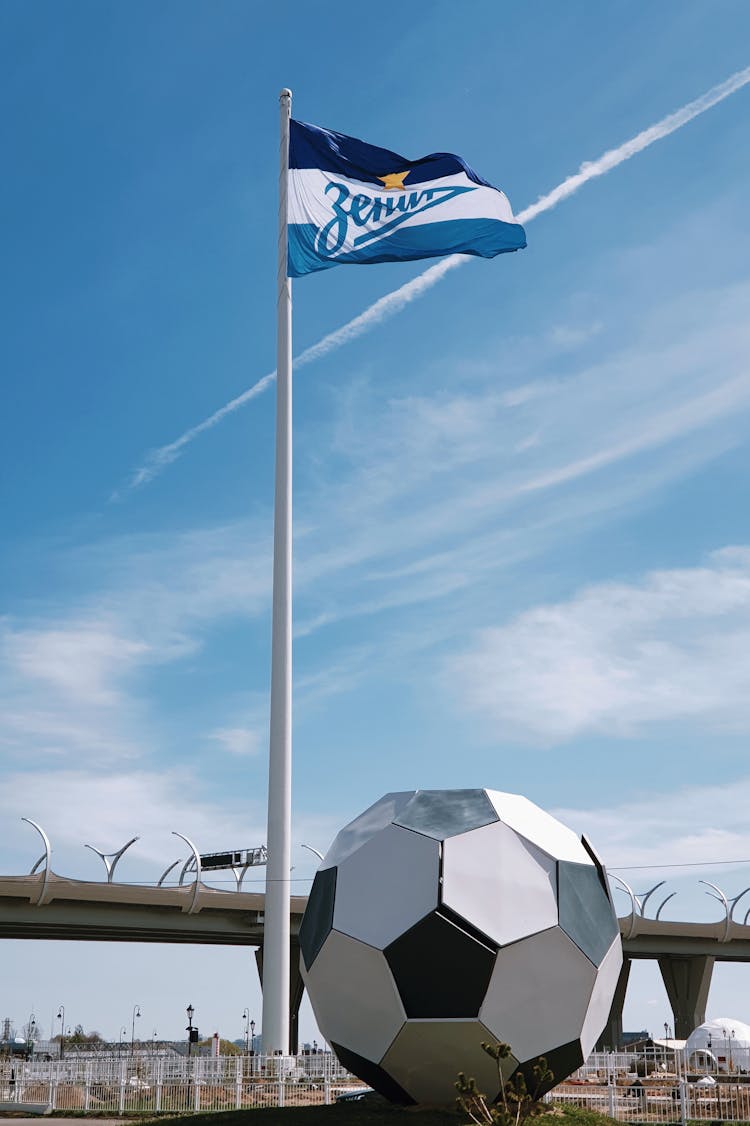 Flagpole And An Installation Of A Football Ball 