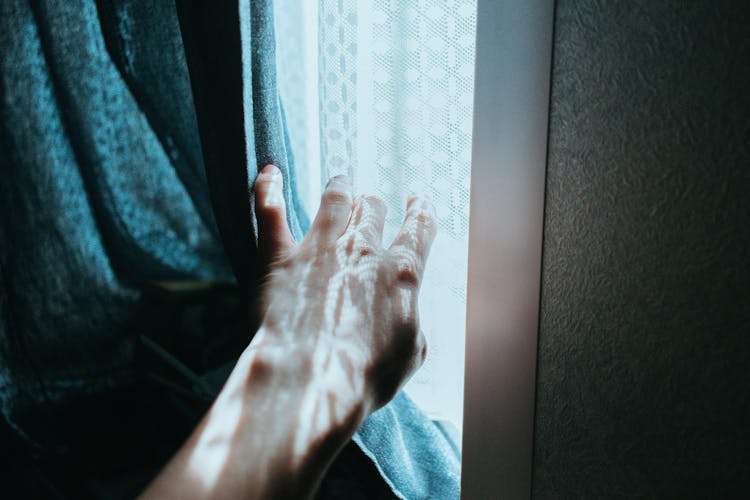 Person Hand Opening Curtain Indoors