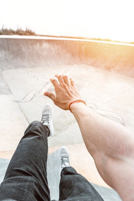 Dynamic view of a skateboarder in action at a skate park in Rabat, Morocco during sunset.
