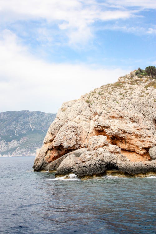 Brown Rock Formation Near Body of Water