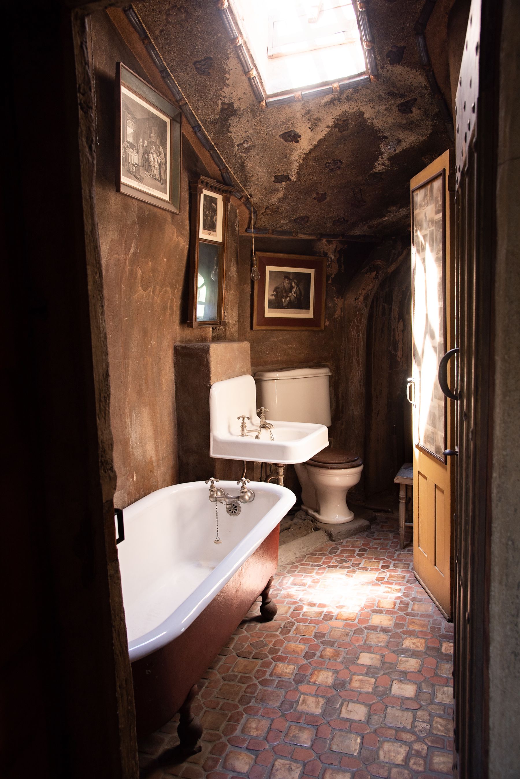 Historic-feeling bathroom with antique clawfoot tub and older architectural character