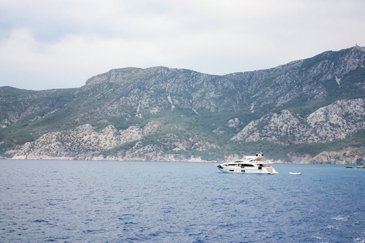 White Boat On Sea Near Mountain