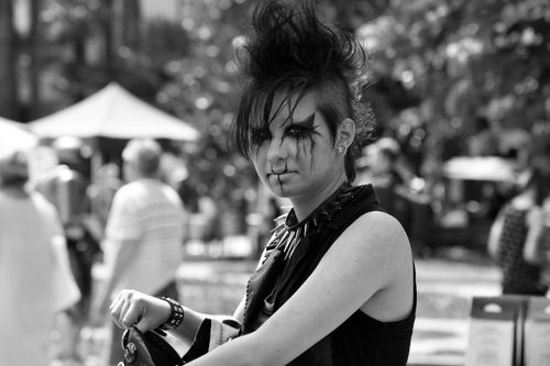 Free Punk style woman with creative makeup and hairstyle in a monochrome outdoor setting. Stock Photo