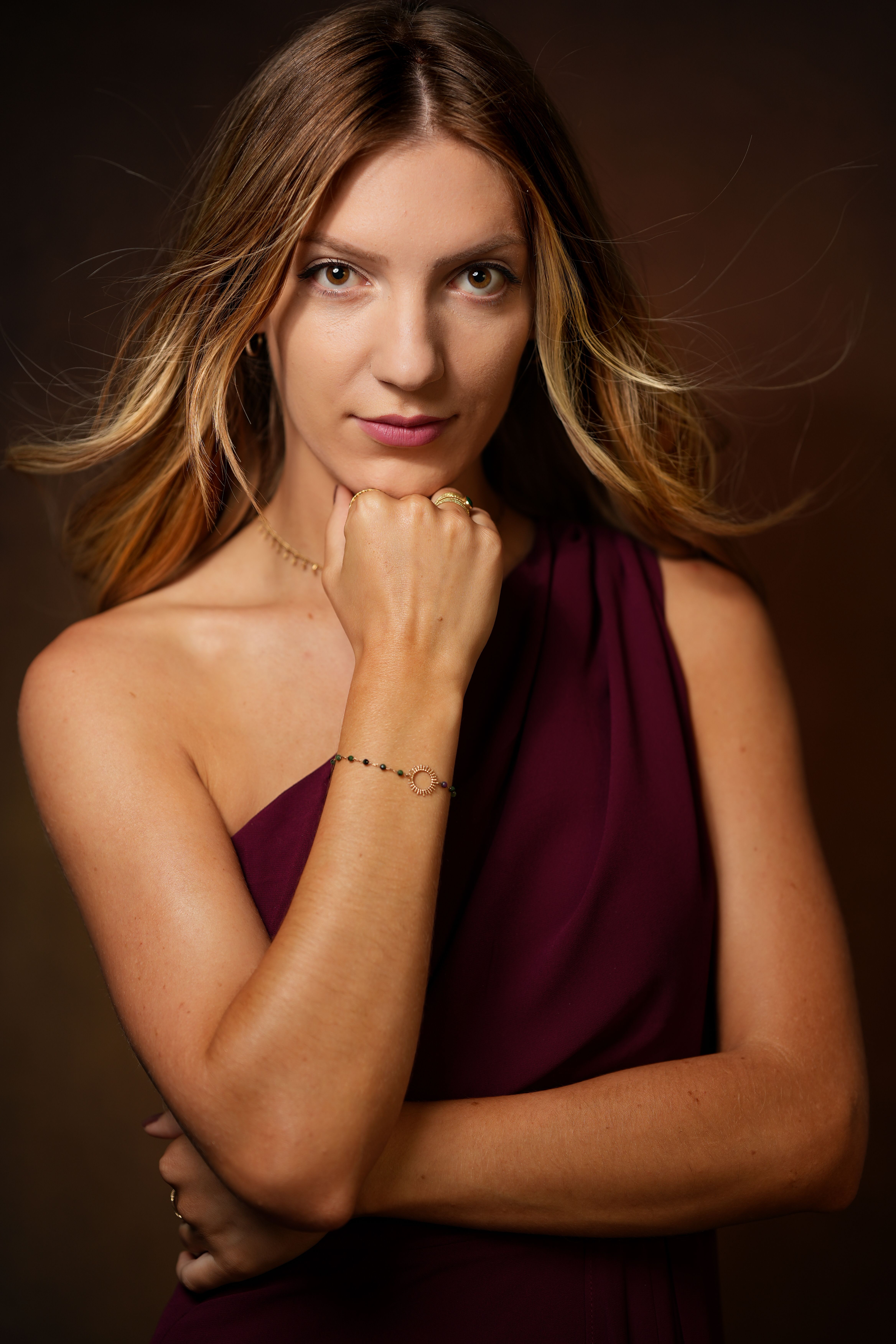 Portrait of a confident woman posing in studio, showcasing elegance and style.