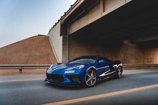 Photo of Blue Corvette Parked on Asphalt Road