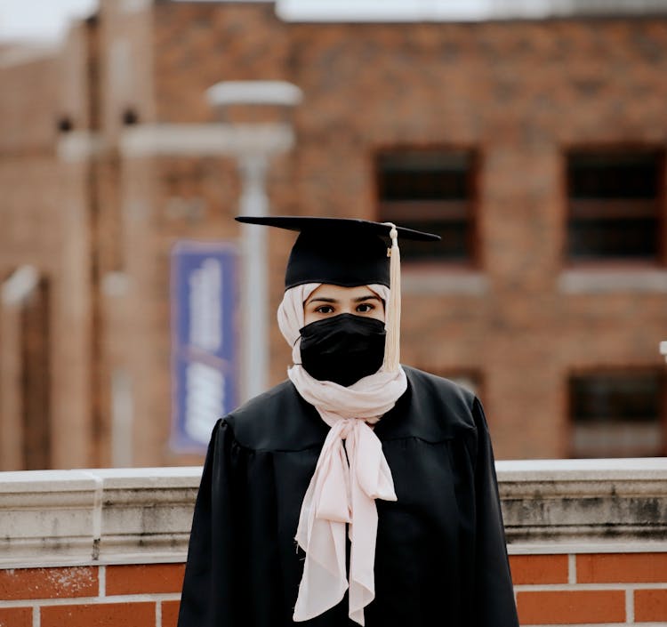 Woman Wearing A Graduation Hat And A Face Mask