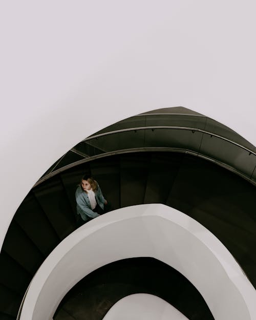 A Woman Going Up a Spiral staircase