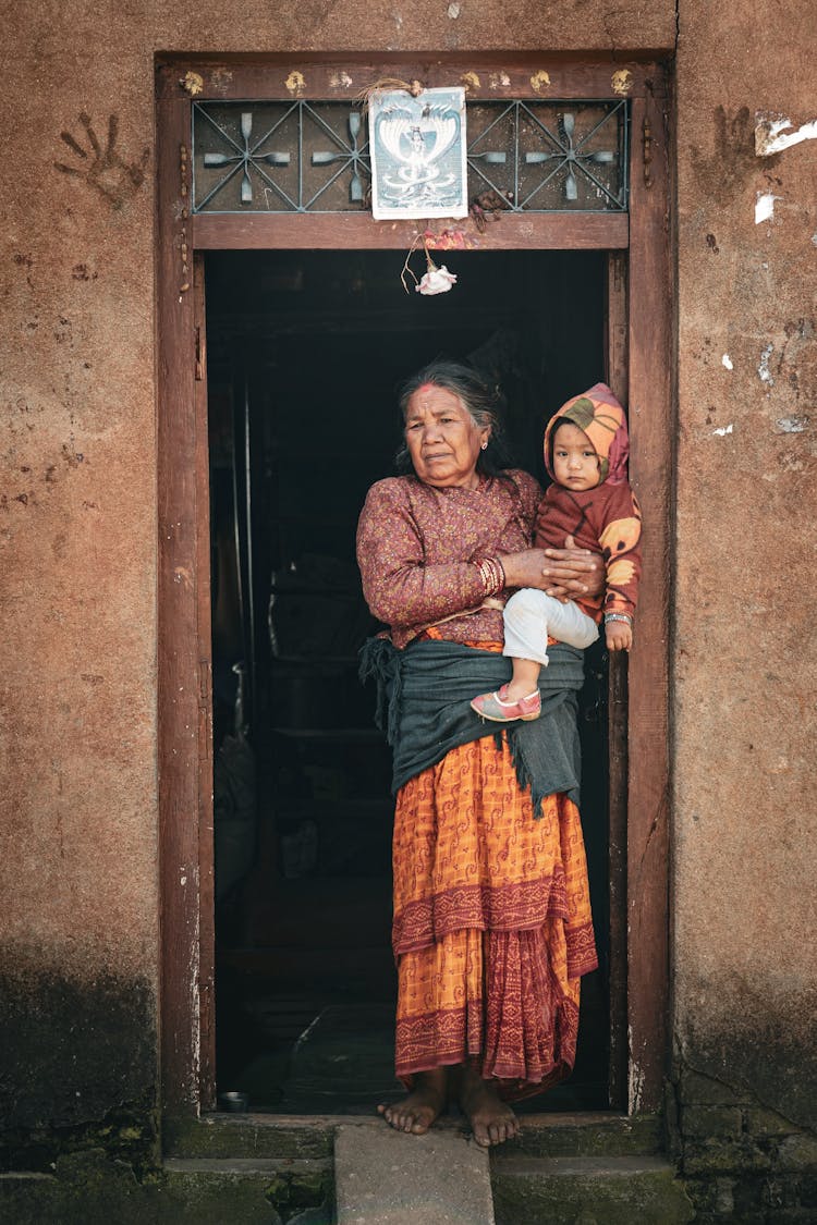 Woman With Baby In Doorway