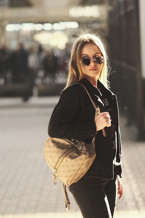 Woman in Black Long Sleeve Jacket with Brown Shoulder Bag 