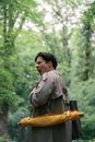Man in Grey Jacket Carrying Brown Bag