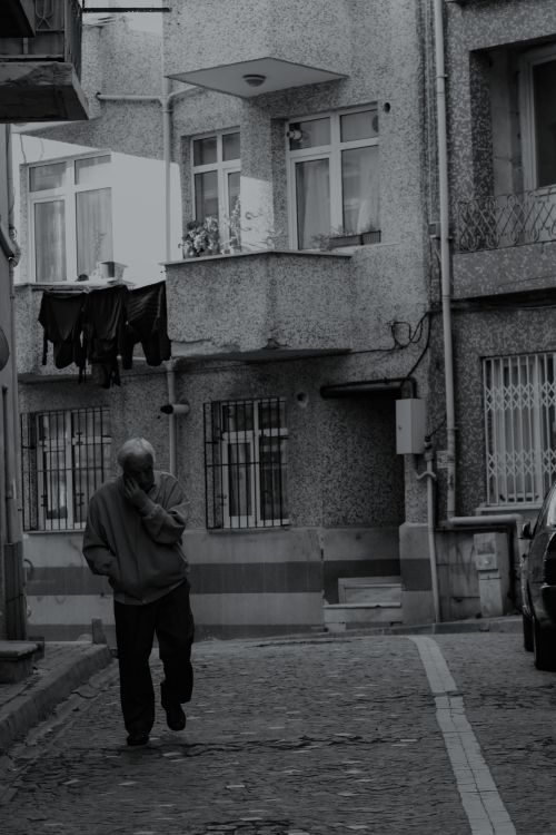 Free Monochrome photo of an elderly man walking in a narrow street in Istanbul, Turkey. Stock Photo