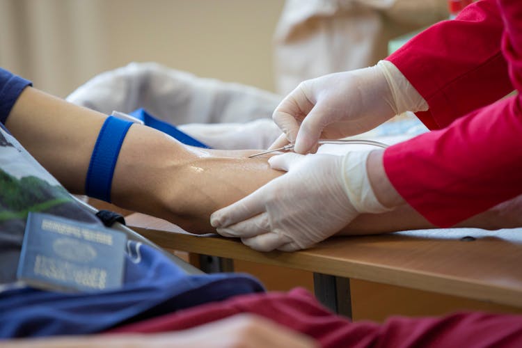 Close-up Photo Of Injecting A Syringe In A Person's Arm 