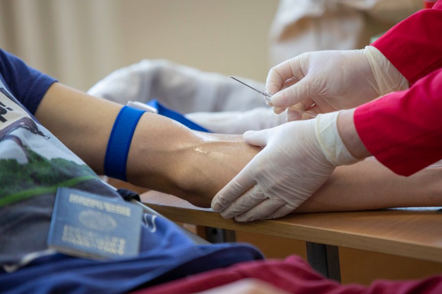 Professional performing an in-home blood draw