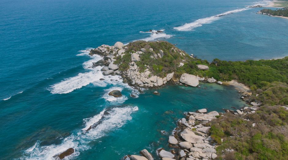 Incredible Private Tour of Guatapé by Helicopter and Boat Review: Colombia's Most Spectacular Dual Adventure Review 2026 - A breathtaking aerial view of Colombia's rocky coastline with turquoise waters and lush greenery.