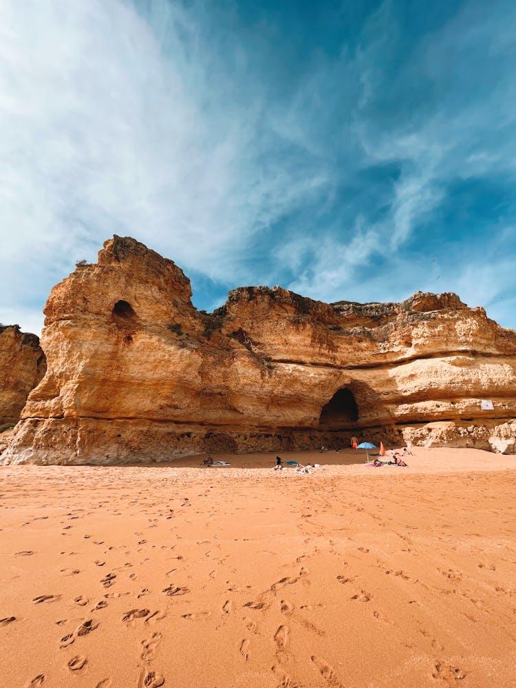 Cliffs With Caves On Beach