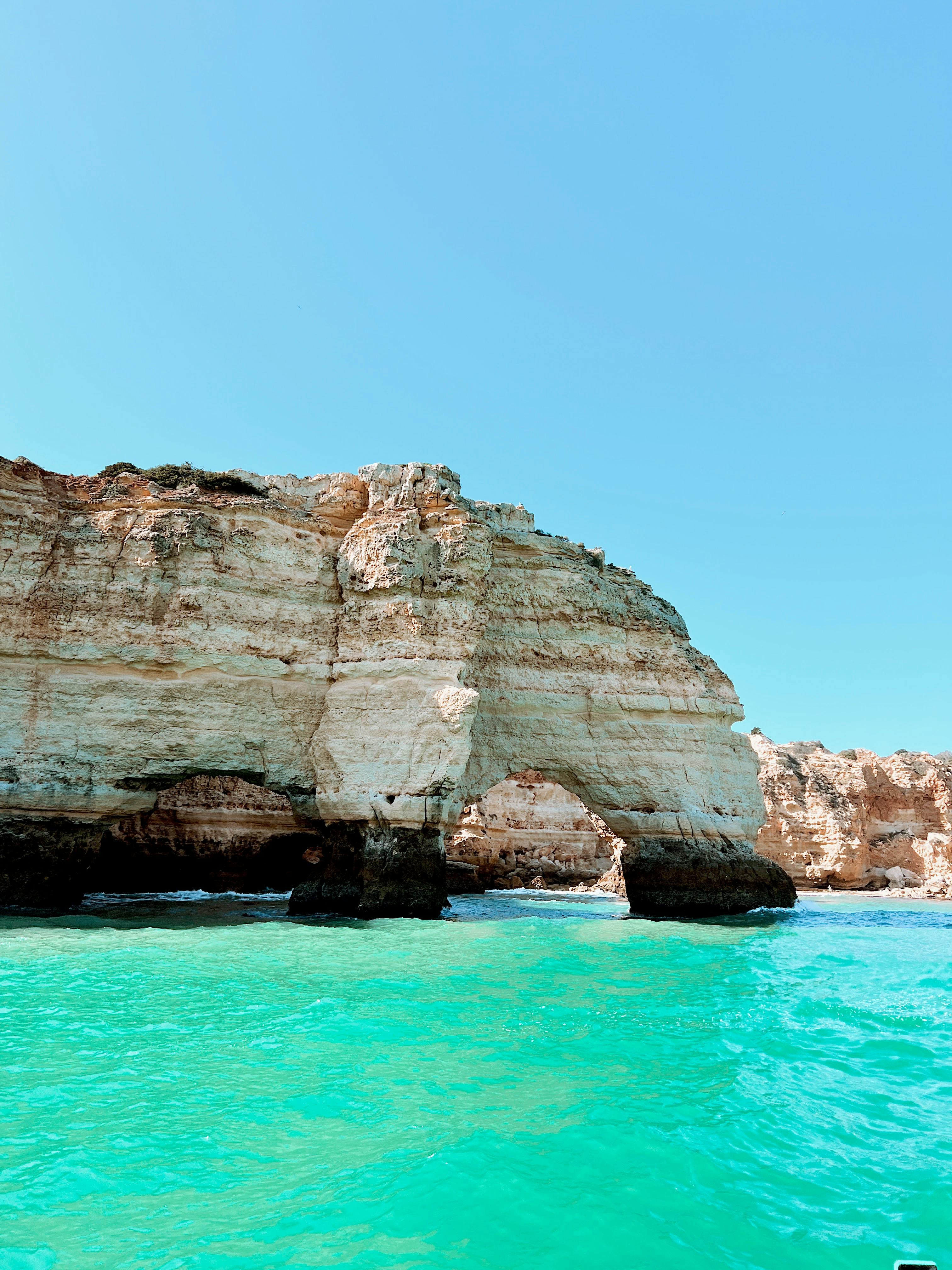 Rock Formations Portruding from Sea · Free Stock Photo