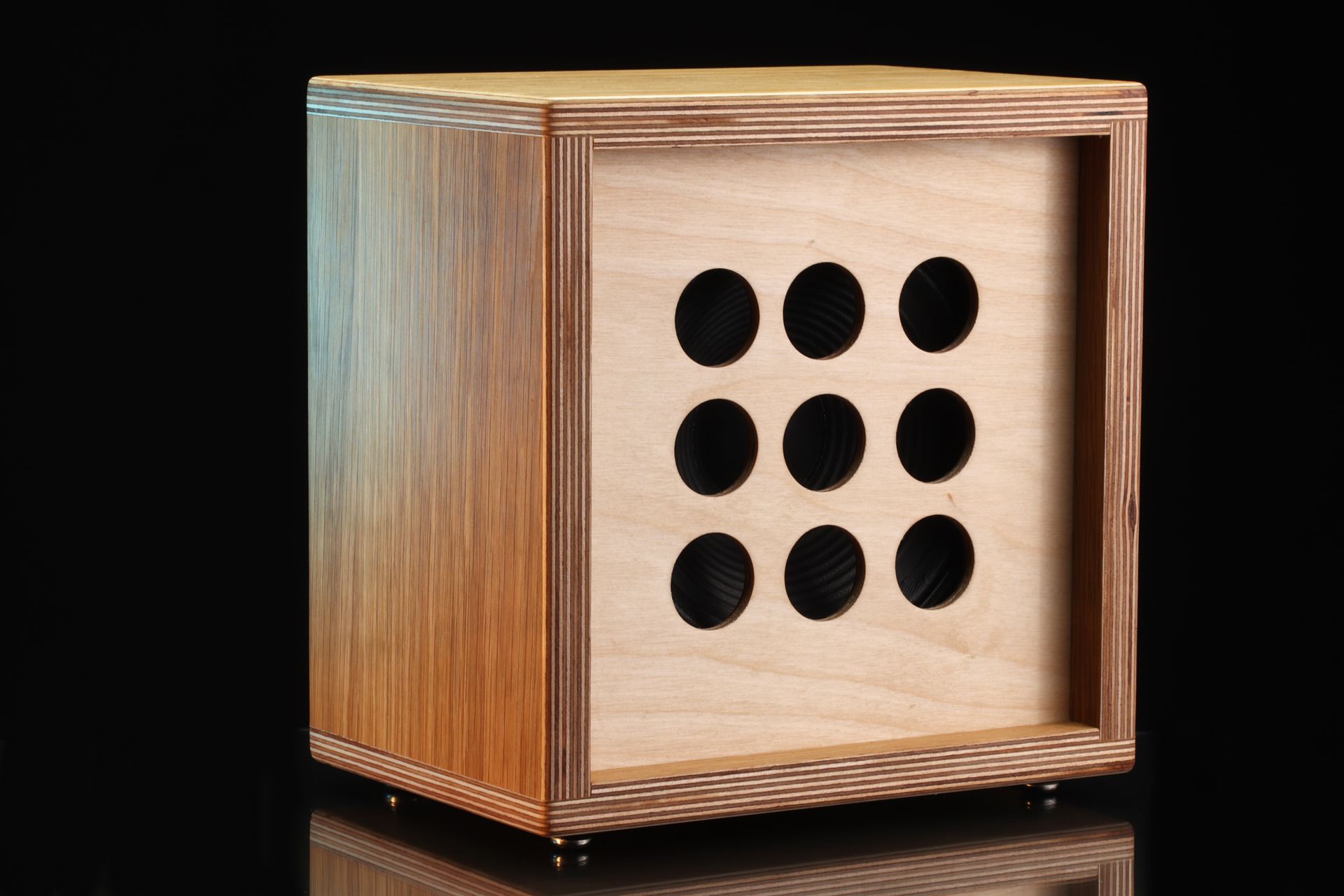 Close-up of a stylish wooden speaker featuring circular cutout design, ideal for modern interiors.
