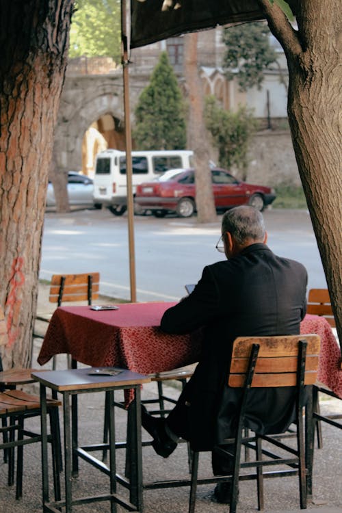 Free Man Sitting in Sidewalk Cafe  Stock Photo