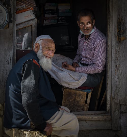 An Elderly Man Sitting on Wooden Bench