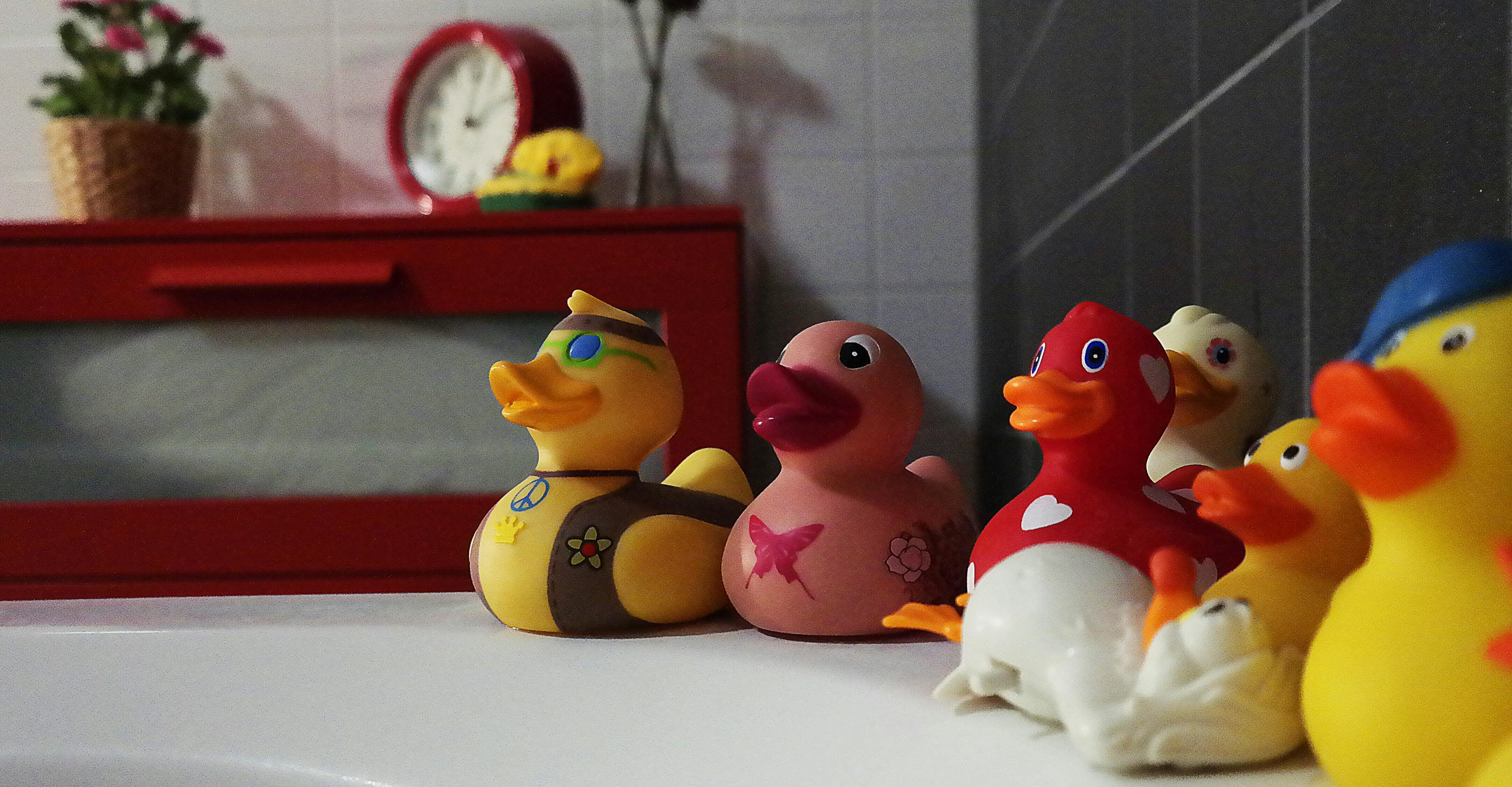 assorted rubber duckies on white surface