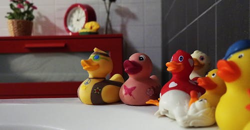 Free Assorted Rubber Duckies on White Surface Stock Photo