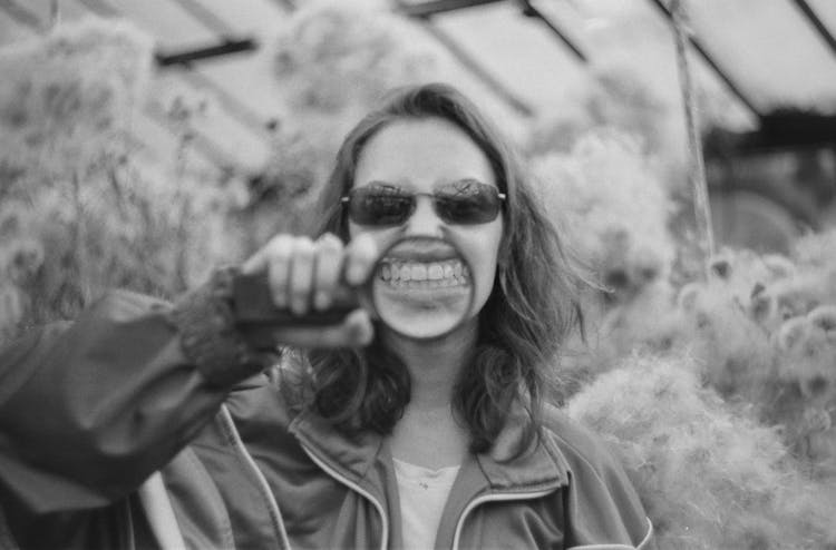 Smiling Man Showing Teeth In Magnifier