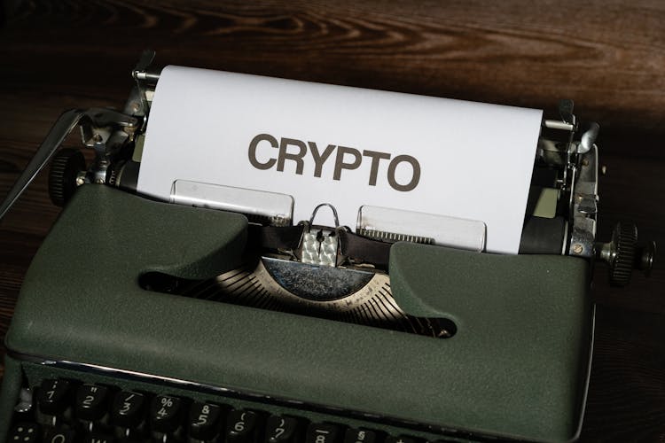 A White Bond Paper With Crypto Text On A Typewriter