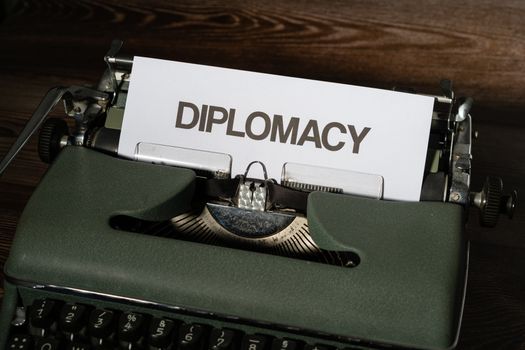 Close-up of a vintage typewriter with the word 'Diplomacy' on a paper sheet.
