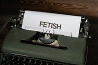 Green and Black Typewriter on Brown Wooden Table