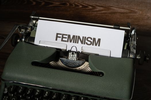 Green and White Typewriter on Brown Wooden Table