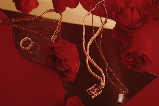A sophisticated display of pearls and gold jewelry elegantly set amidst vibrant red roses on a rich red surface.
