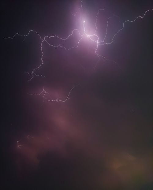 Free A striking image of lightning illuminating the night sky, creating a moody and dramatic atmosphere. Stock Photo