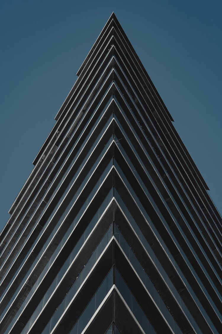 A Glass Building With Sharp Edge Under Blue Sky