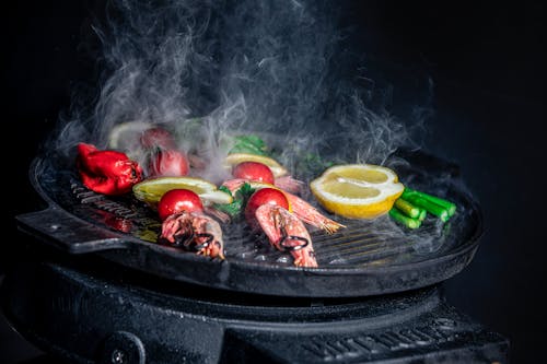 A Set of Shrimps and Tomatoes on Sticks on a Grill Pan