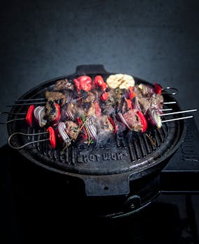 Tasty grilled skewers with meat and vegetables on a BBQ grill.