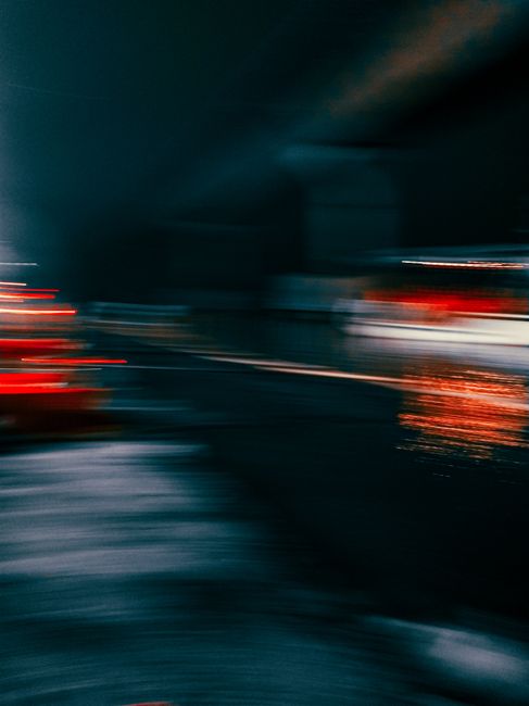 Dynamic blurred city traffic lights at night creating an abstract visual effect.