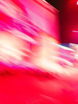 A vivid abstract image with dynamic motion blur in bright red tones, creating a dramatic artistic effect.