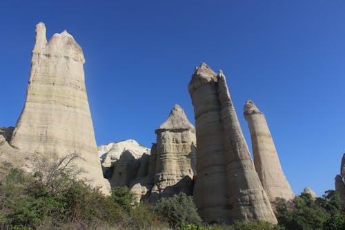 A Low Angle Shot of a Rock Formations Under the Blue Sky