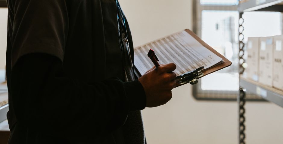 A person completing a checklist on a clipboard — HACCP certification is assessed on documented systems rather than appearance
