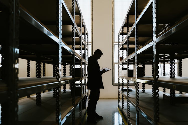 Person With Clipboard In Warehouse