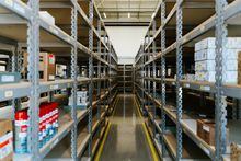 Industrial warehouse with metal parts shelving, photo by Daniel Andraski on Pexels