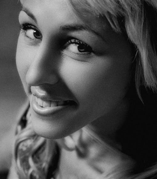 Free Close-up Shot of a Woman Smiling at the Camera Stock Photo