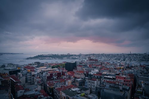 Aerial View of Cityscape Under Dark Clouds