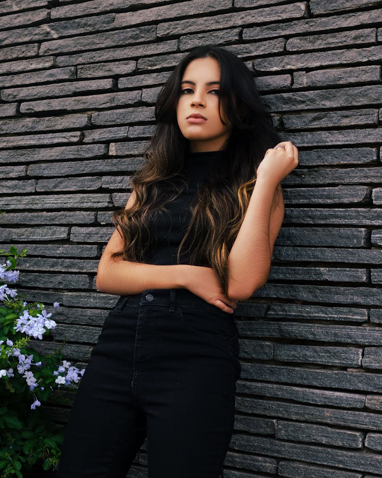 Photo Of A Teenager Girl Leaning On The Wall By Back