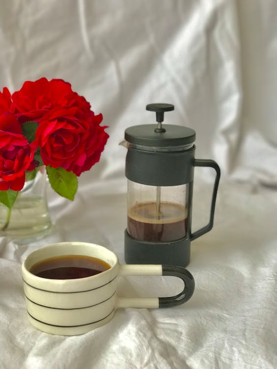 Red Rose Beside White Ceramic Mug With Coffee
