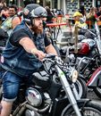 Man in Black T-shirt and Blue Denim Jeans Riding on Black Motorcycle