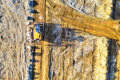 Free Aerial View of a Heavy Equipment on Brown Sand Stock Photo