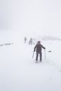 People Walking on Snow Covered Field
